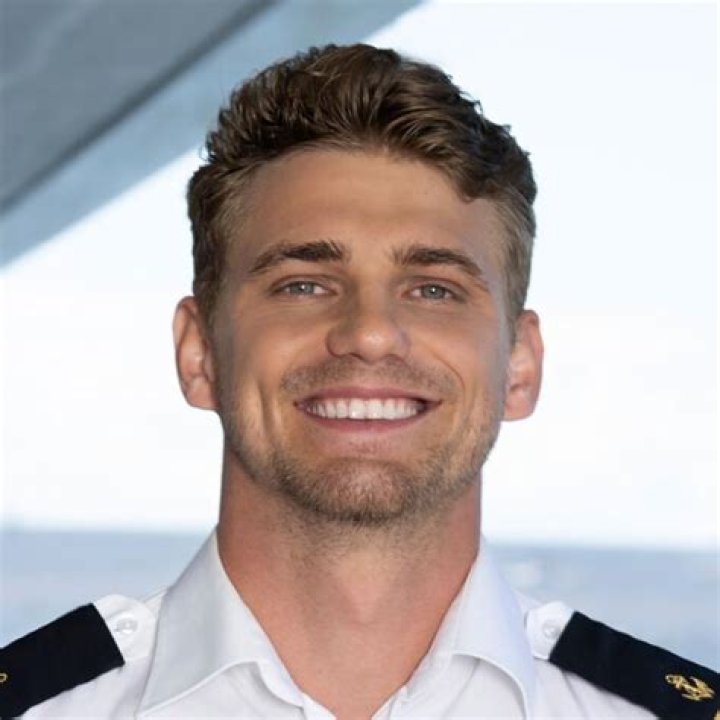 Adam Lukasiewicz from 'Below Deck Down Under' poses in uniform.