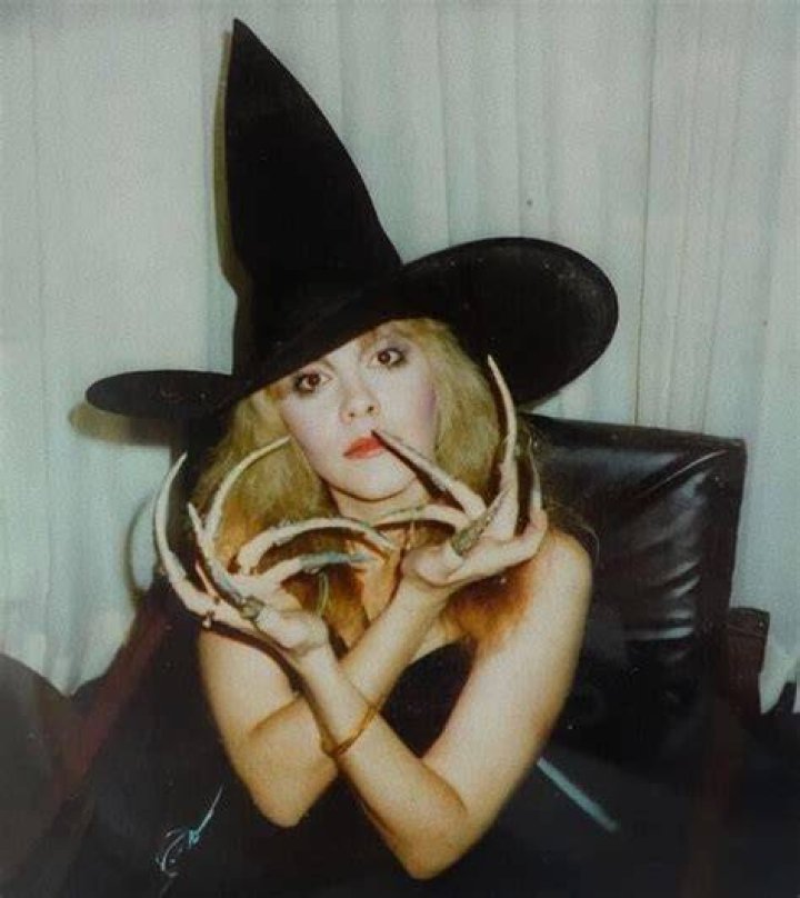 Stevie Nicks in her witch like outfit during a concert.