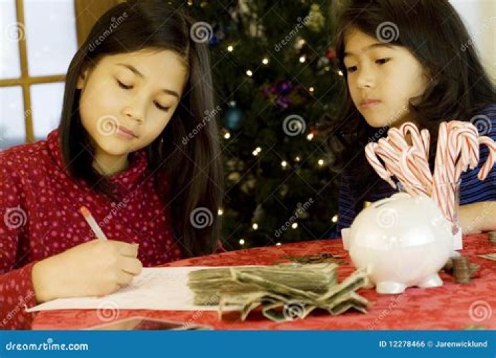 Two young girls counting money at their lemonade stand