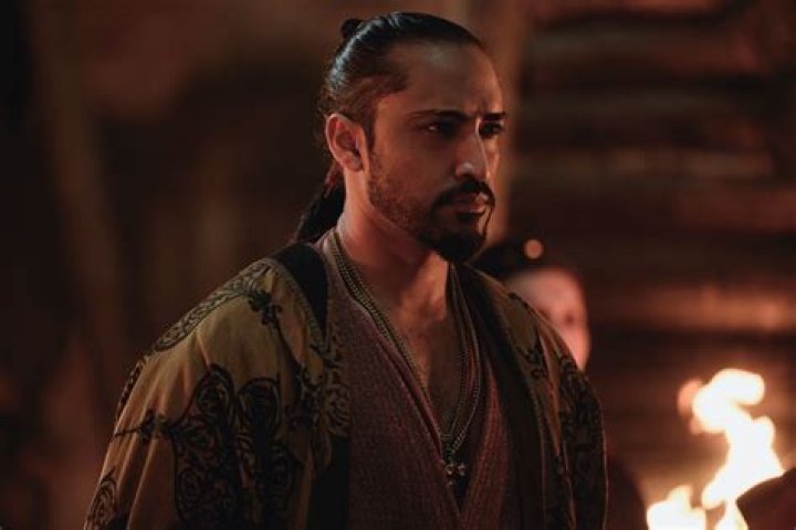 Vilgefortz sitting in a robe in 'The Witcher.' 